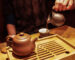 Pouring,Dark,Pu-erh,Tea,From,A,Purple,Clay,Jar,Into